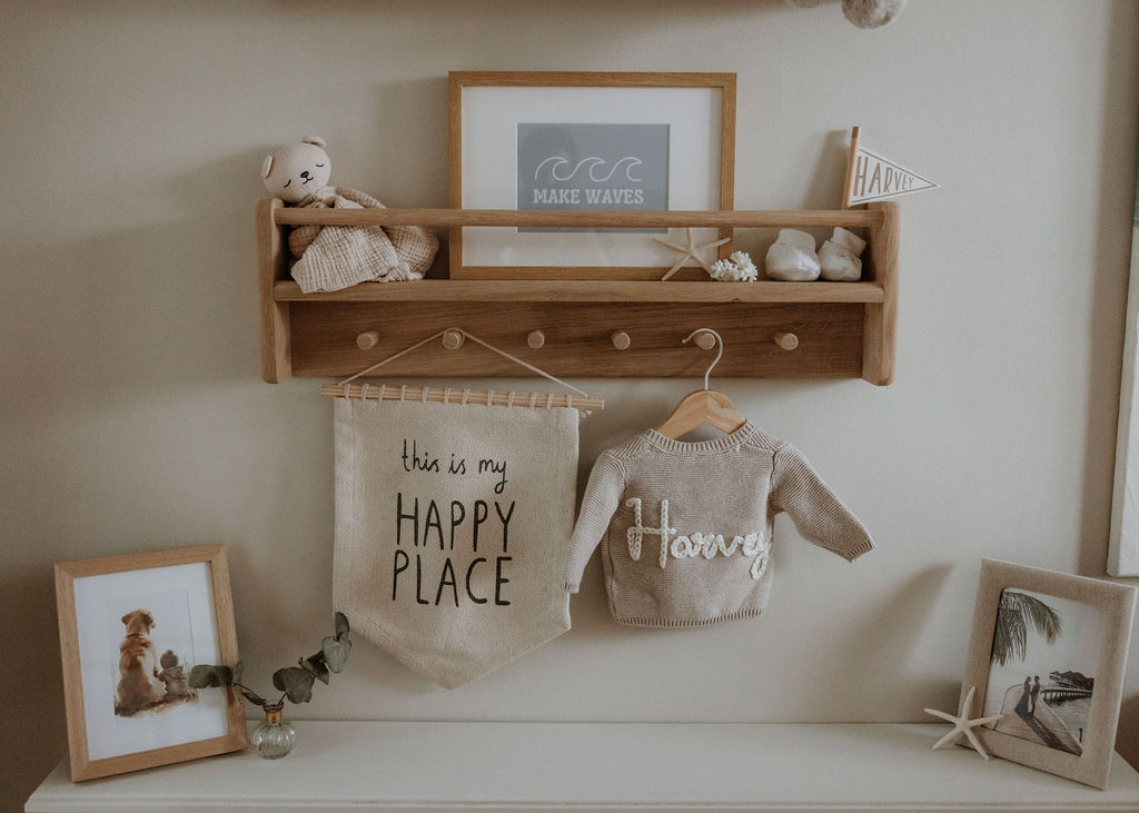 Close-up of baby's first teddy bear and bookshelf arranged for newborn photography session