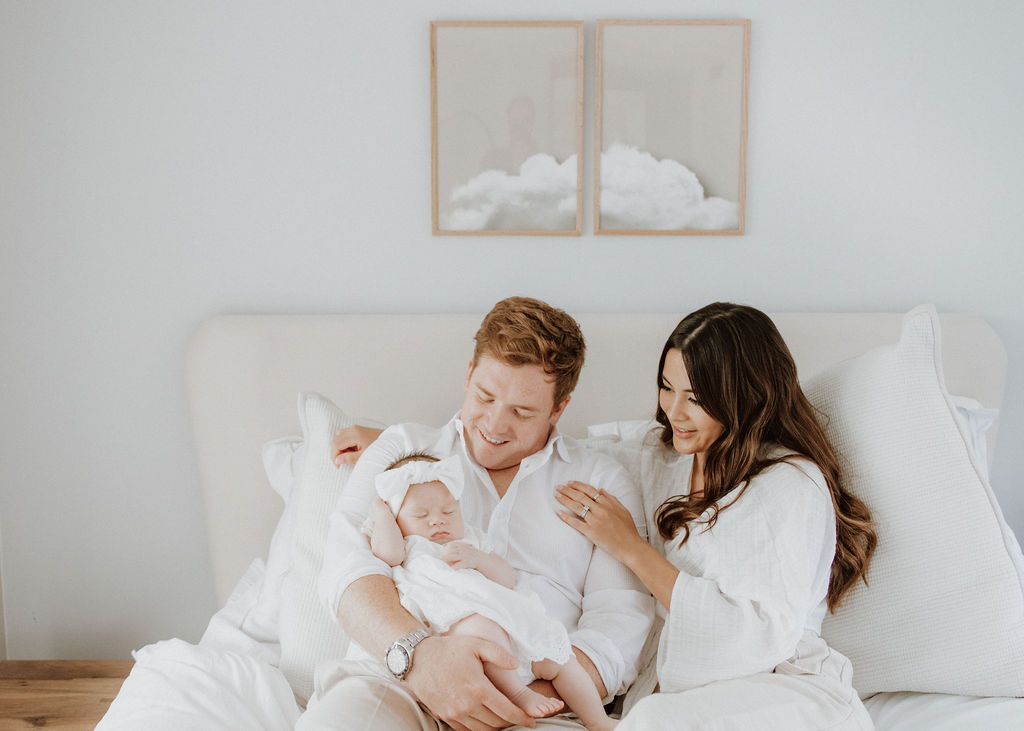 Intimate moment between couple during a relaxed luxury in-home maternity and newborn photography session in London.